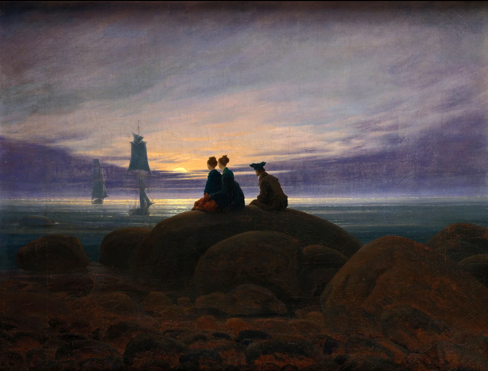 Three figures sit together on coastal rocks, watching distant sailing ships beneath a rising moon.
